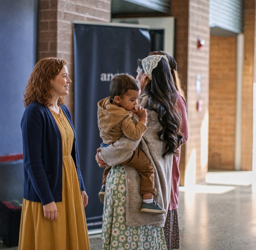 Women of King’s Way visiting together, one holding a toddler